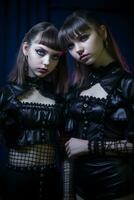 two young women in black leather outfits posing for the camera generative ai photo