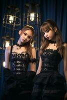 two young women in black dresses standing next to each other generative ai photo
