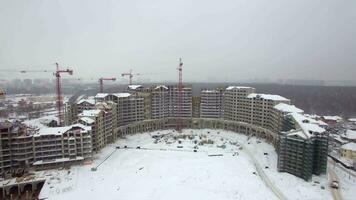 An aerial view of a multi storey building construction in the snow video