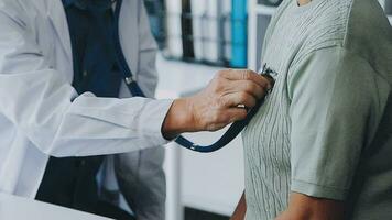 close up doctor, Asian doctor talk with old female patient about disease symptom, doctor use stethoscope listening lung of patient, elderly health check up, happiness hospital video