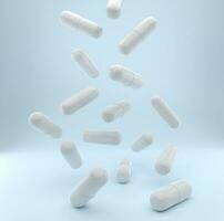 Falling pills on a light blue background photo