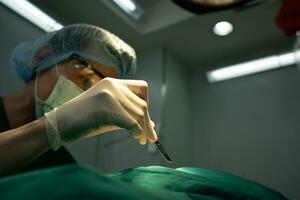 Asian Professional surgeons team performing surgery in the operating room, surgeon, Assistants, and Nurses Performing Surgery on a Patient, health care cancer and disease treatment concept photo