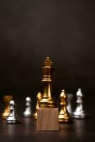 Golden king chess standing on a wooden stand. The concept of Leaders in good organizations must have a vision and can predict business trends and assess competitors photo