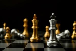 Silver King chess standing in front of other chess, Concept of a leader must have courage and challenge in the competition, leadership and business vision for a win in business games photo