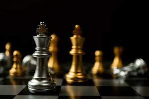 Silver King chess standing in front of other chess, Concept of a leader must have courage and challenge in the competition, leadership and business vision for a win in business games photo