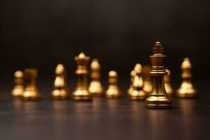 Golden Chess King standing to Be around of other chess, Concept of a leader must have courage and challenge in the competition, leadership and business vision for a win in business games photo