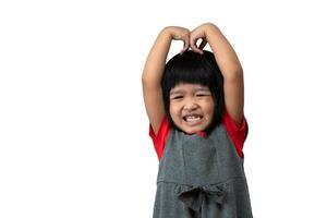 Portrait of happy and funny Asian child girl on white background, a child looking at camera hand gesture. Preschool kid dreaming fill with energy feeling healthy and good concept photo