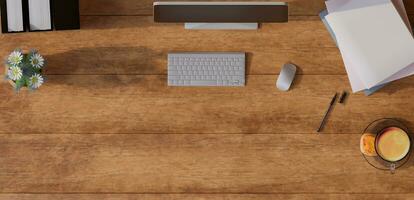 A desktop with a Monitor, keyboard, mouse, coffee, books, pens, and decorations on top. 3d rendering. photo