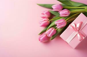 Bouquet of pink tulips and gift box on pink background.Generative AI. photo