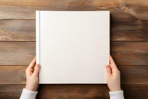 Book Mockup in Kid's Hands Holding Top View on Wood Table Background , AI-generated photo