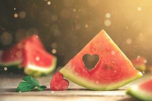 A cut piece of watermelon with a heart-shaped hole. Summer, joy, happiness, delicious food photo