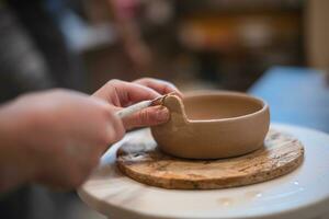 girl hands, pottery studio and painting cup in workshop for sculpture photo