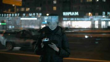 Woman at the bus stop passing time with tablet computer video