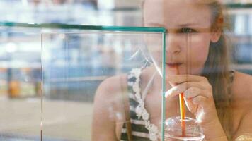 Woman looking through the window of a bakery video