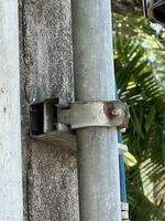 rusty iron pipes with a white wall photo