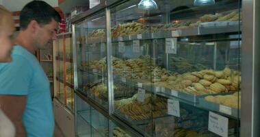 Couple choosing tasty cookies in the grocery video