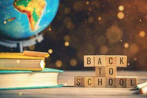 books, stationery on the table on a black chalkboard. Education, September 1, new academic year photo