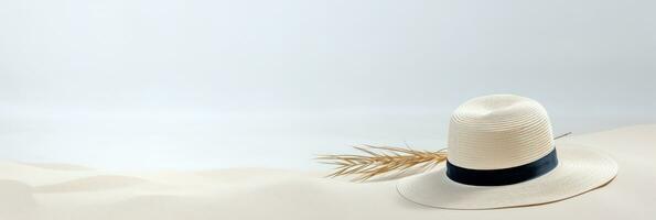 Summer background with straw hat and white sand with empty copy space photo