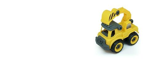 Yellow plastic truck toy isolated on white background. construction vechicle truck. a copy space for banner of toy store. photo