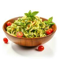 Freshly made zucchini spaghetti zoodles in a bowl garnished with cherry tomatoes and basil leaves isolated on a white background photo