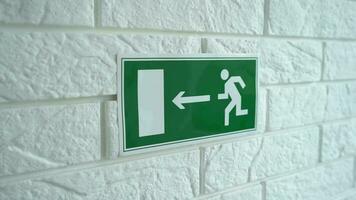 Exit emergency sign in 4K slow motion. An exit sign hangs on a wall. 4k stock footage. video