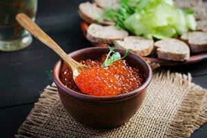 Salmon red caviar in bowl. Delicious food. photo