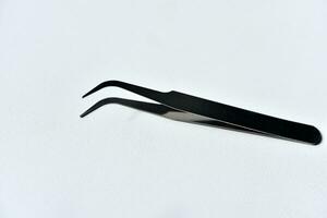 Metal tweezers. A tool for repairing electronics. photo