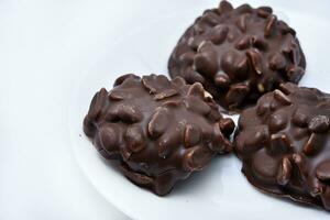 Chocolate chip cookies with nuts. Sweet appetizer on a white plate. photo