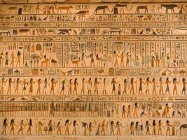 egyptian hieroglyphic glyphs on the wall of the egyptian temple photo