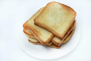 Fried toast on a white plate. Baked bread for sandwiches. Vegan food. photo