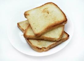 Fried toast on a white plate. Baked bread for sandwiches. Vegan food. photo