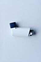 Aerosol asthma inhaler pocket on a white background. A remedy for asthma. The inhaler. photo