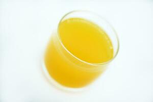 Glass glasses with orange juice on a white background. Delicious orange cooling drink. photo