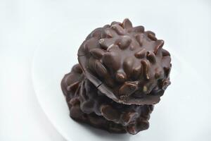 Chocolate chip cookies with nuts. Sweet appetizer on a white plate. photo