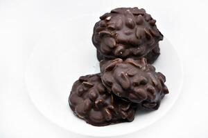 Chocolate chip cookies with nuts. Sweet appetizer on a white plate. photo