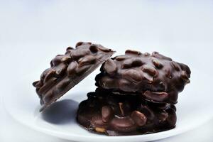 Chocolate chip cookies with nuts. Sweet appetizer on a white plate. photo