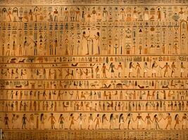 egyptian hieroglyphic glyphs on the wall of the egyptian temple photo