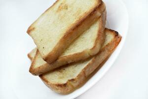 Fried toast on a white plate. Baked bread for sandwiches. Vegan food. photo