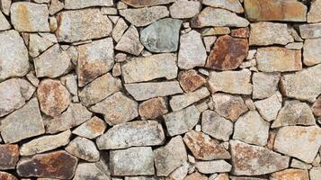 Masonry wall paving stone, rough natural stone backdrop and background, middle age style. photo