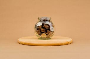 Saving money in a glass bottle Finance and investment, coins, generating income, cash flow, income, salary, wages, mutual funds, dividends photo