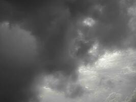 Black gray clouds form causing rain, and seasonal storms. The rain clouds that were formed caused a thunderstorm. For weather forecasters reporting the weather in the rainy season or stormy season. photo
