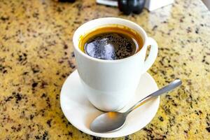 Cup of americano black coffee in restaurant Costa Rica. photo