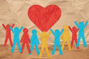 Paper colorful people and a red heart. The concept of love and kindness, donation photo