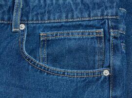 Blue jeans front pocket with buttons photo