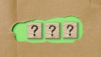 Wooden cubes with question marks, the concept of searching for truth, getting information photo