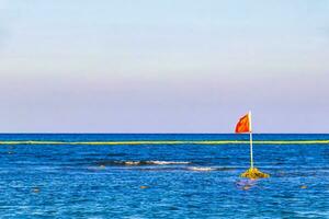 Red flag swimming prohibited high waves Playa del Carmen Mexico. photo