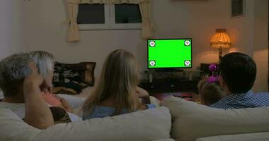 Family watching TV at home, chroma key video