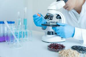 Scientist analyze biochemical samples in advanced scientific laboratory. Medical professional use microscope look microbiological developmental of viral. Biotechnology research in science lab. photo