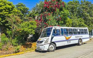 Puerto Escondido Oaxaca Mexico 2022 Various colorful buses tour bus transport in Puerto Escondido Mexico. photo