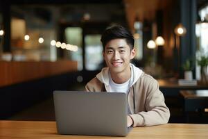 Portrait of Cheerful Male Student Learning Online in Coffee Shop, Young Asian Man Studies with Laptop in Cafe, Doing Homework photo